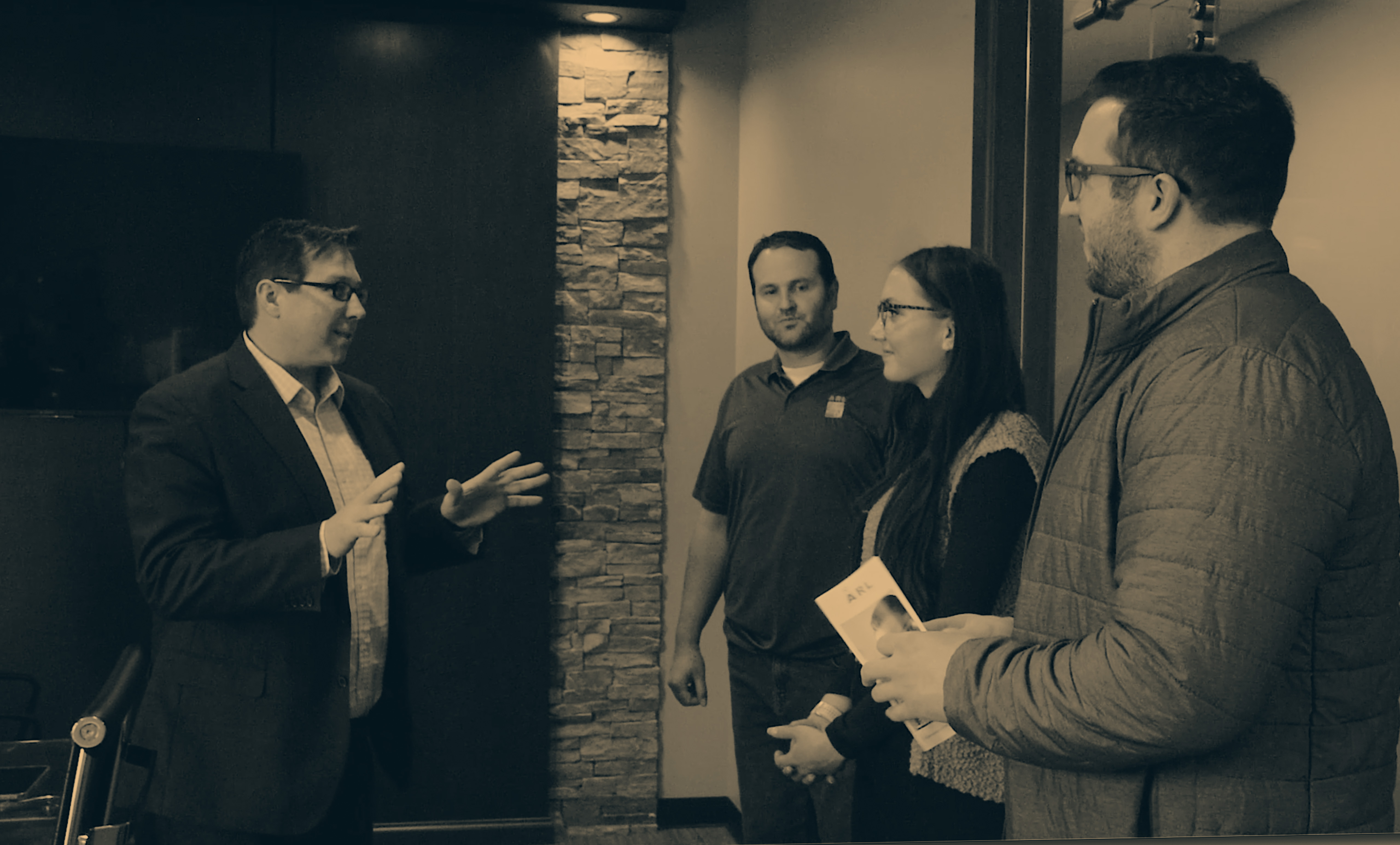 CEO Matt Lewis talking with ARL partners in his office.